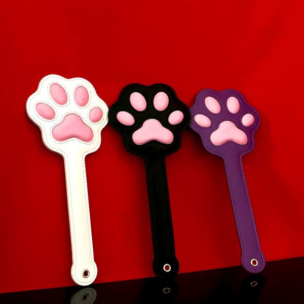 Alt: Pink Paw Print Leather Spanking Paddle Title: Cute Leather BDSM Paddle with Paw Design