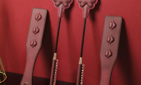 ALT: Cute paw print leather spanking paddle in white, black, and purple