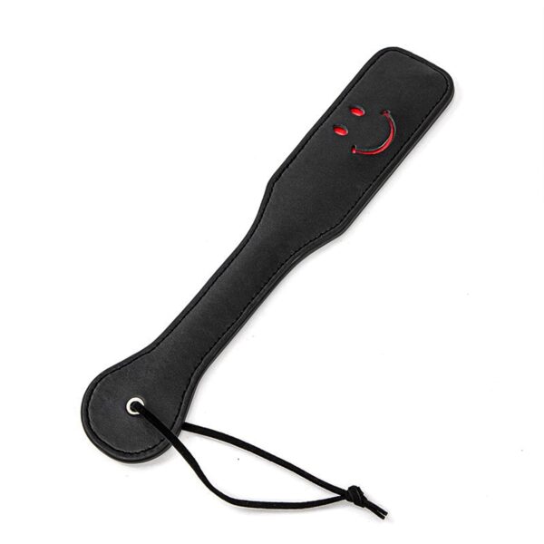 Smiley face spanking paddle with faux leather design