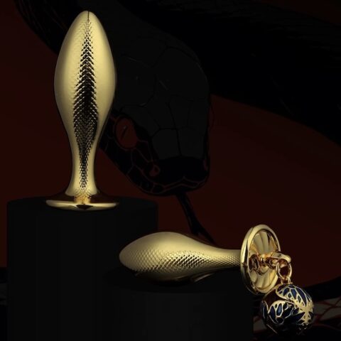 Gold fish-shaped metal butt plug with textured scale surface