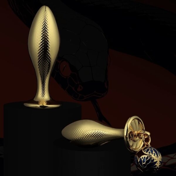 Gold fish-shaped metal butt plug with textured scale surface