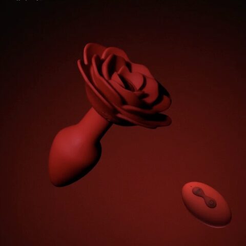 Remote-controlled rose-shaped vibrating butt plug on dark red background