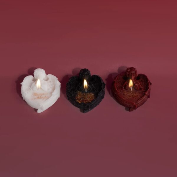 Three gothic angel candles burning in black, red, and white on a dark red backdrop